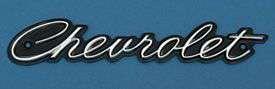 Chevr Scrip Grille Emblem,1965